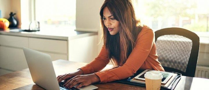 A woman browsing in front of a laptop